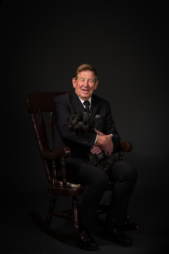 Location photographic portrait of a man and dog using a mobile studio