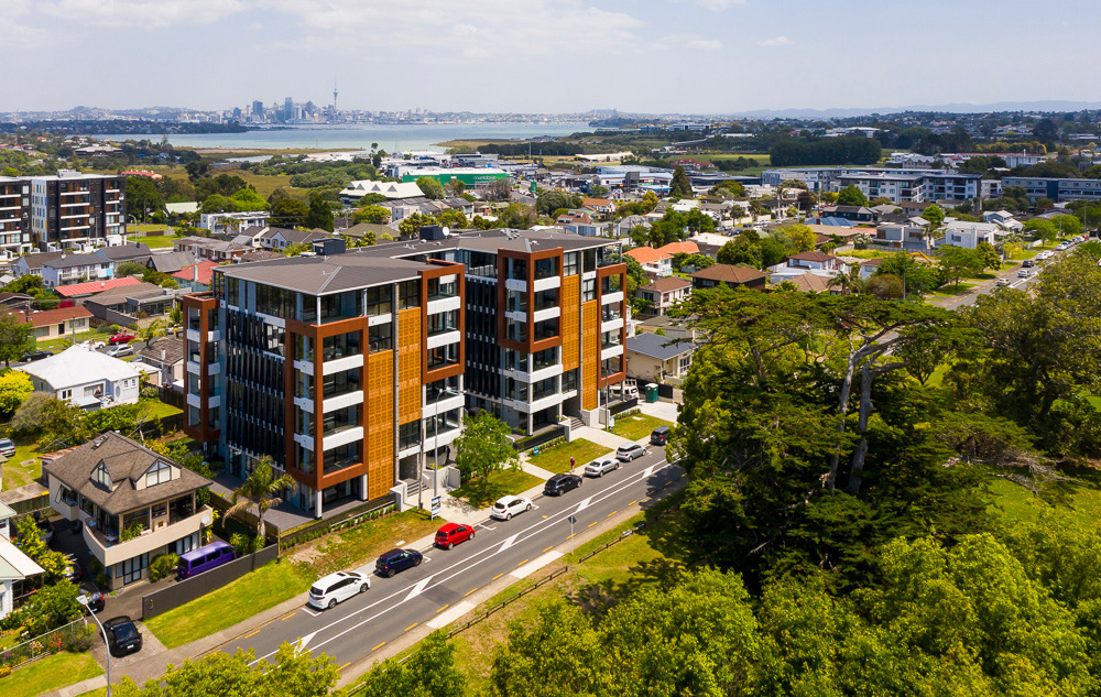 Image of large building project from the air, same angle but from above shows the surrounding suburb