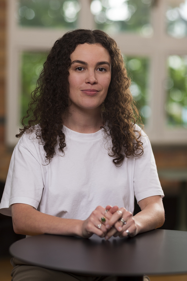 Environmental portrait of a woman sitting at a table