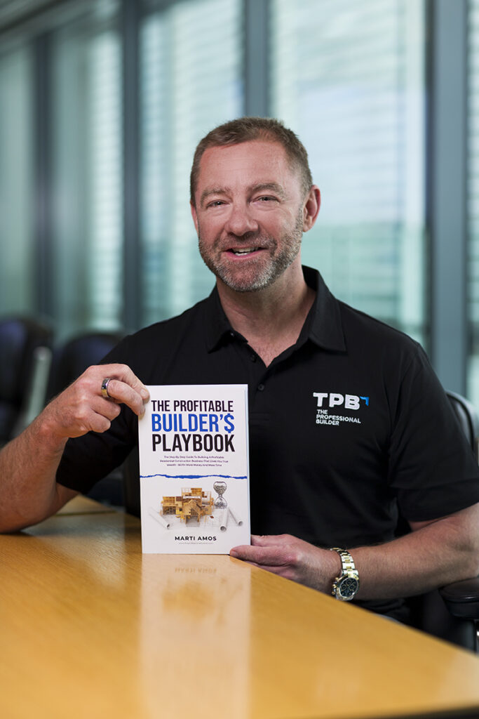 headshot of CEO with a book he has written on building