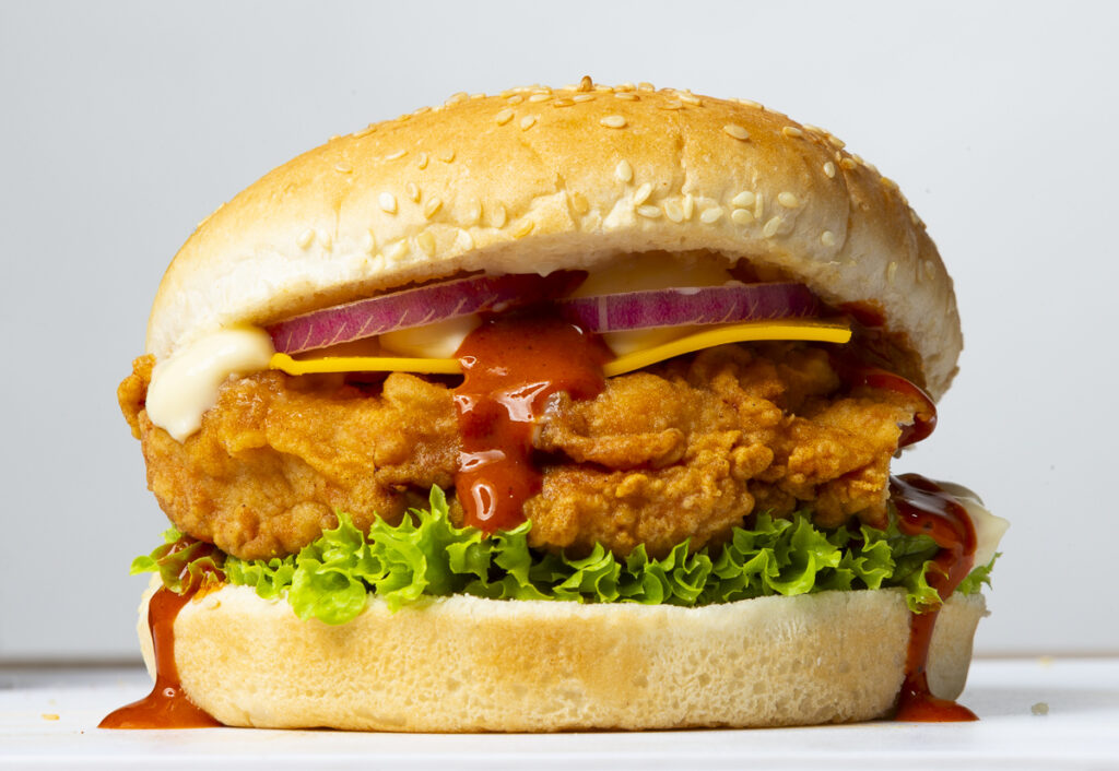 professional photograph of a chicken burger on a white background for later clearcutting and menu use