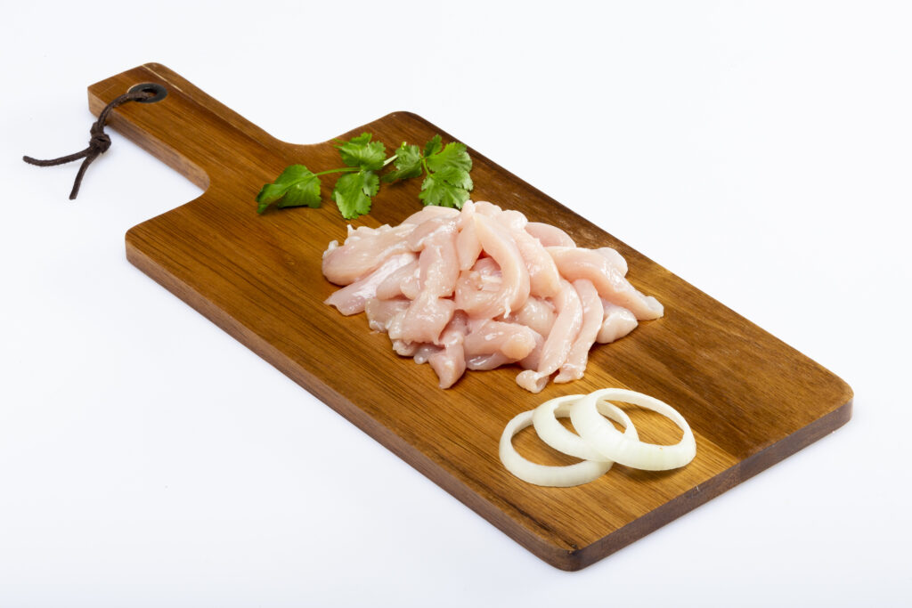 food photography of diced chicken on a simple plain white background for later background removal