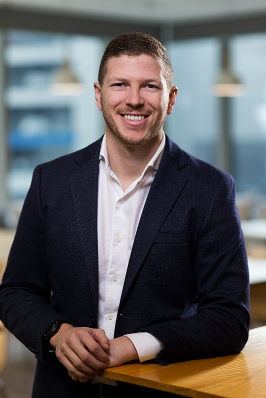 Headshot of male staff member captured in an Auckland office during a headshot photoshoot